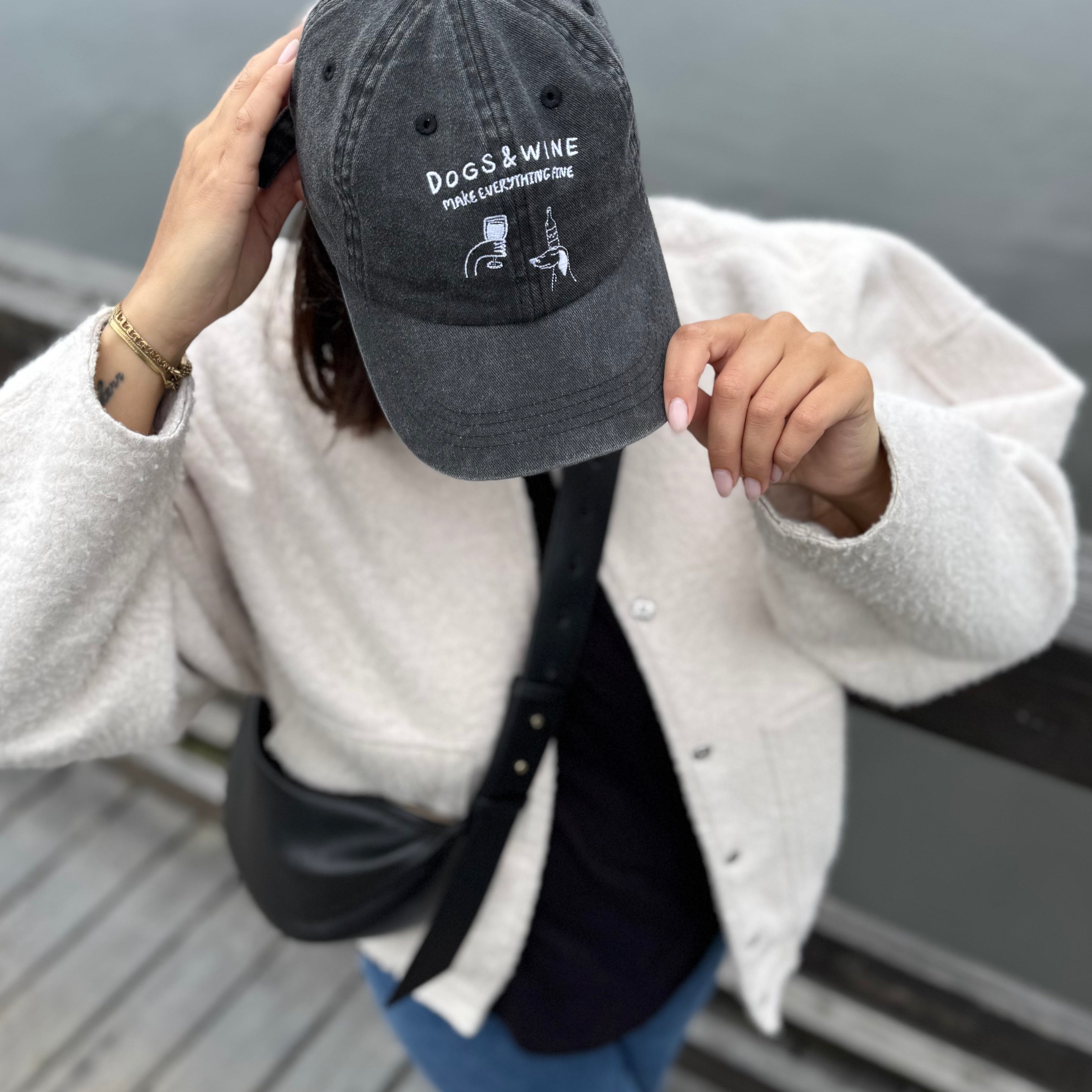 black-denim-cap-dogs-and-wine-logo-woman-wearing.jpg